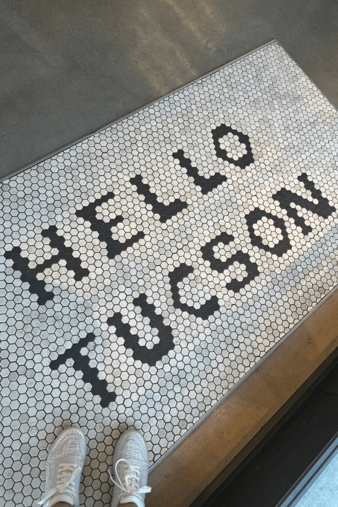 Standing on a mat that says Hello Tucson
