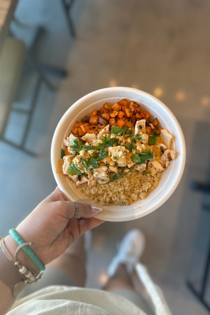 Hand holding bowl with food in it