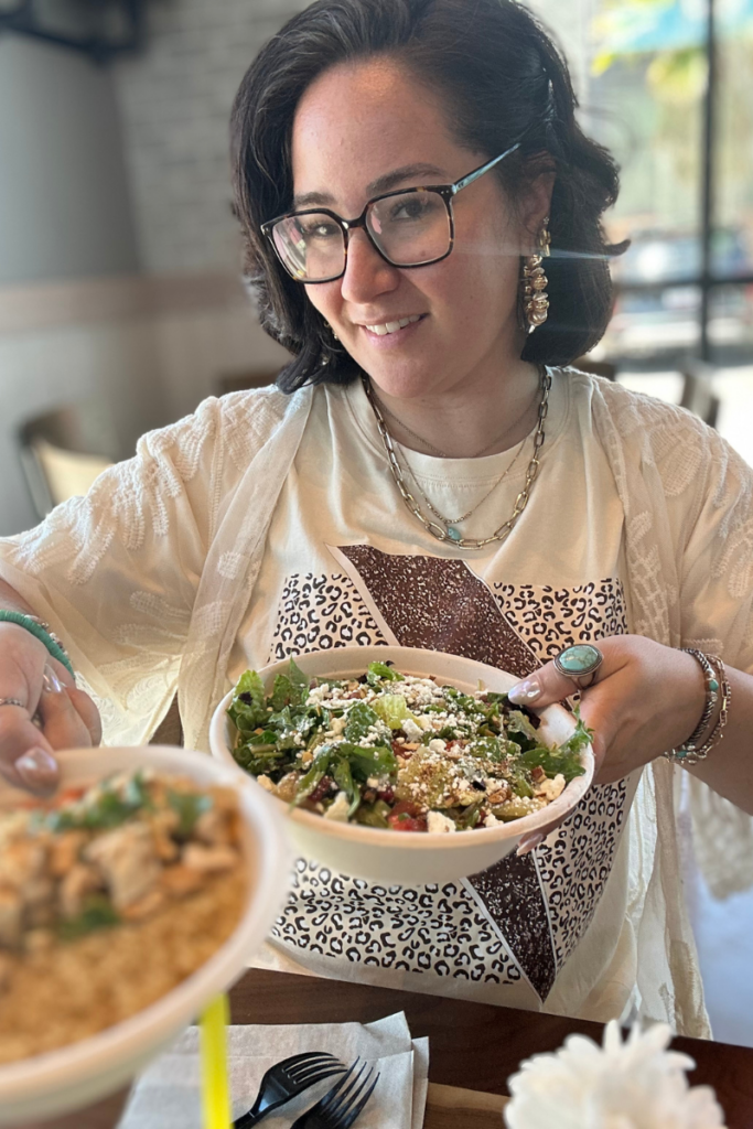 Woman holding two bowls with food in them